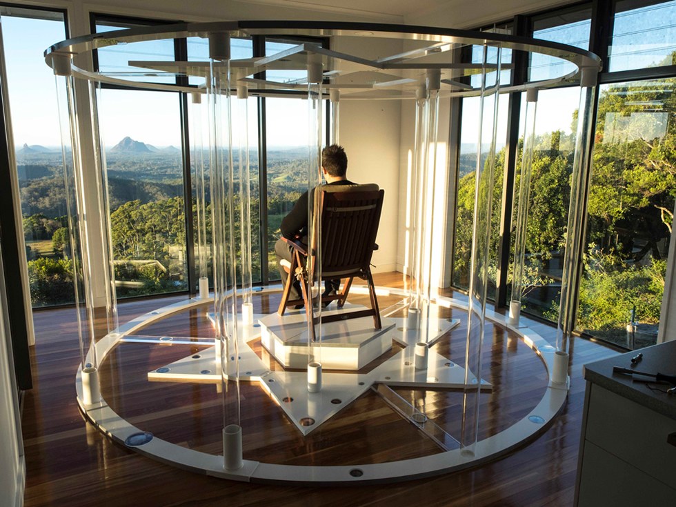 Christopher Lewin seated inside the Teslas Starhenge on the deck at Maleny